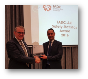 Mark Denkowski, IADC Executive Vice President, Operational Integrity, presents the onshore safety award plaque to Leigh Foreman, SLB Operations Manager.