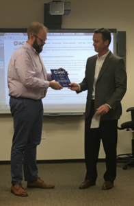 Jason McFarland presents an award to Brad Green, IADC Manufacturing Record Book Subcommittee Chairman
